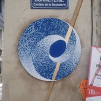 a blue and white sign on the side of a building