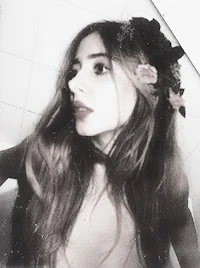 a black and white photo of a woman in a bathroom