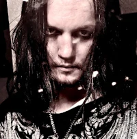 a black and white photo of a man with long hair