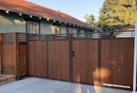 a brown wooden gate in front of a house