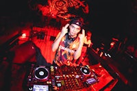 a dj with a microphone in front of a red light