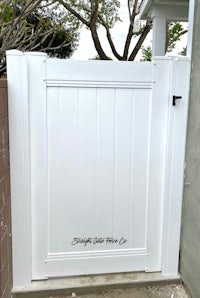 a white gate in front of a house