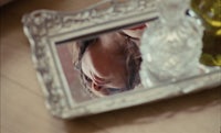 a woman's face in a mirror