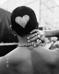a man with a heart tattoo on his back