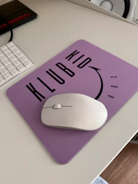 a mouse pad on a desk with a keyboard and mouse