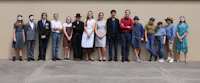 a group of people posing in front of a wall