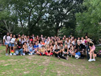 a group of people posing for a photo in a park