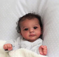 a baby is laying in a white blanket