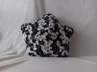 a crocheted star shaped pillow on a bed