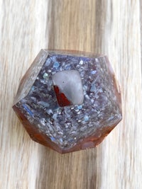 an opal stone with a red and white stone on top