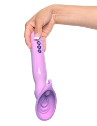 a woman's hand holding a purple vibrating toy