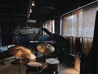 a drum set in a room with a piano