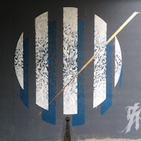 a painting of a blue and white circle on a wall