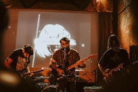a group of people playing a musical instrument in a room