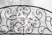 an iron gate with a pink heart on it