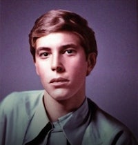 a young man in a blue shirt