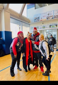 a group of people posing for a photo in a gym