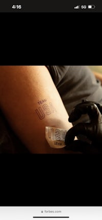 a person is getting a tattoo on their arm