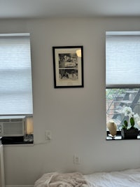 a bedroom with a bed and a picture on the wall