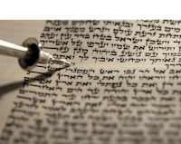 a hebrew text with a pen in it