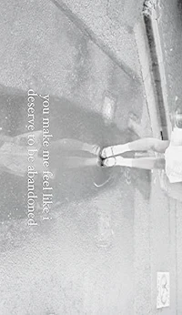 a person holding a skateboard in a puddle