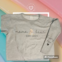 a grey t - shirt with the words mama bear on it