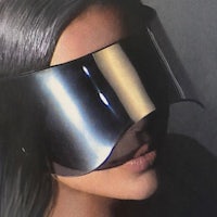 a woman wearing a silver visor with black hair