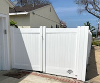 a white fence in front of a house