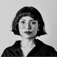 a black and white photo of a woman with glasses