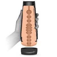 a hand holding a bottle with a sex toy inside