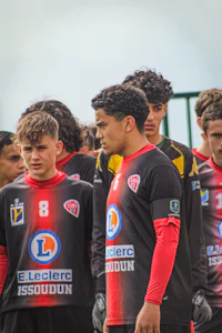 a group of soccer players standing next to each other