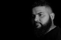 a black and white photo of a man with a beard