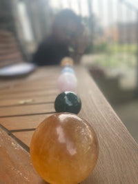 a group of different colored crystal balls on a wooden table