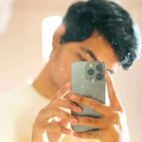 a man taking a selfie with his iphone 11