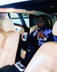 a man sitting in the back seat of a car