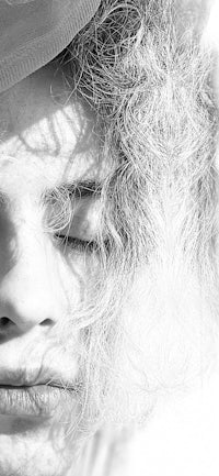 black and white photo of a woman with curly hair