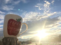 a mug with a quote on it sits on top of a tree stump