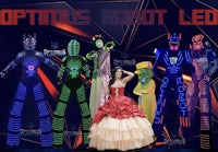 a group of people dressed in costumes with the words optimus robot led