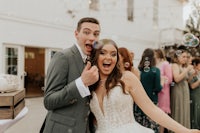 a bride and groom blowing bubbles at their wedding reception