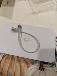 a white box with a cable attached to it
