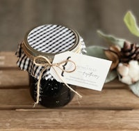 a jar of blackberry jam on a wooden table