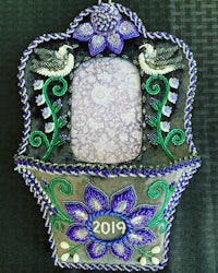a blue and purple embroidered picture frame