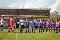 a group of soccer players standing on a field
