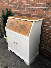 a white desk with an ornate design on it