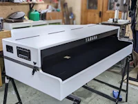 a yamaha piano sitting on a table in a workshop