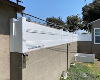 a white fence next to a yard