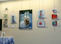 a display of paintings on a wall