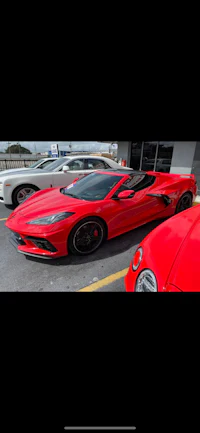 a red sports car parked in a parking lot