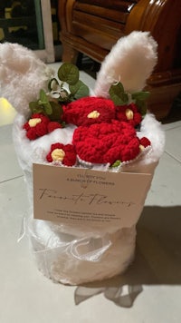 a crocheted bunny hat with flowers in it