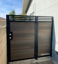 a wooden gate in front of a house